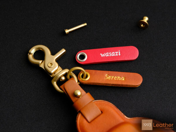 Personalized keychain accessories with free leather tag engraved for Mini Paceman key fob covers, featuring gold hardware.