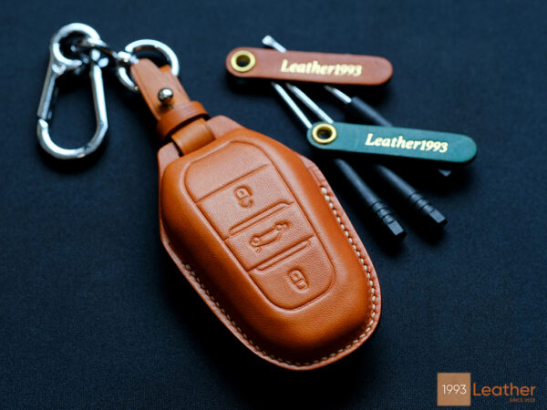 Peugeot 208 key fob cover made of premium Veg-Tanned leather, representing durability and elegance for key protection.