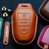 Peugeot 208 key fob cover made of premium leather, featuring exquisite stitching and a refined design for durability and elegance.