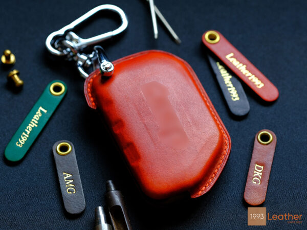 You can have any name engraved on key fob cover's tag.