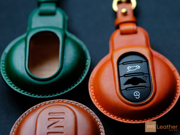 Mini key fob covers crafted from high-quality veg-tanned leather in green and tan finishes.