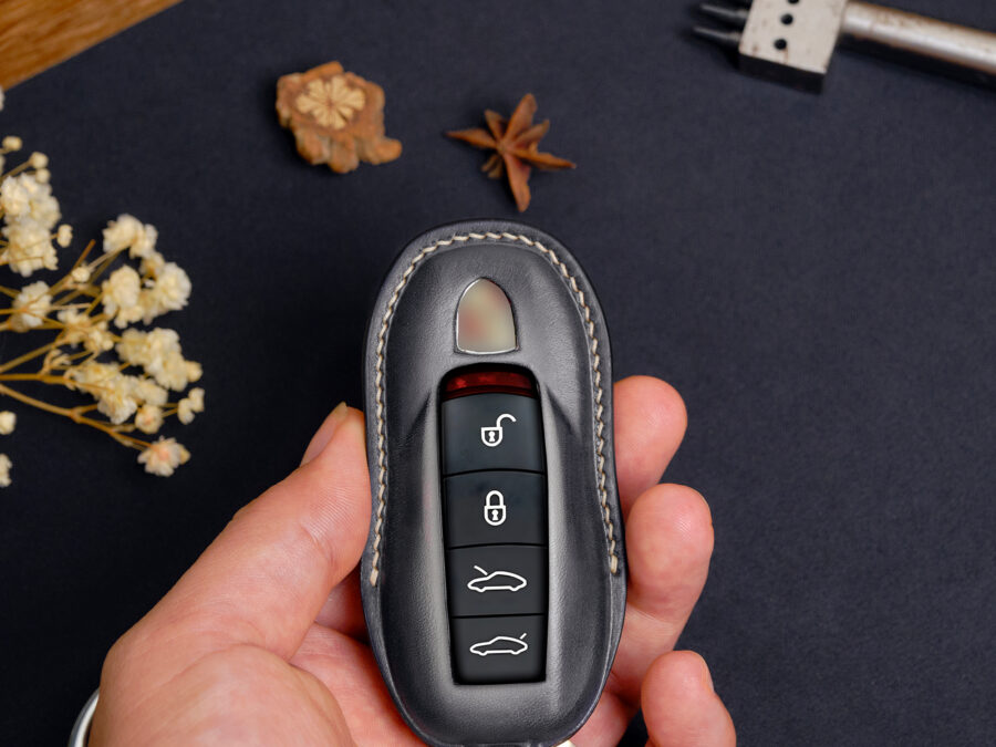 Luxury handcrafted Porsche 718 leather key fob cover for, with stitching and a keychain.