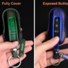 Comparison of two Porsche 718 leather key cases: one with fully-covered buttons in and another with exposed buttons leather, both featuring handcrafted stitching and key tag personalized.