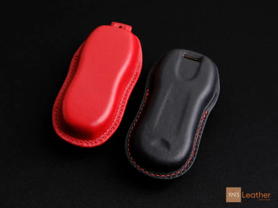 Close-up of Porsche Panamera key fob cover, featuring meticulous stitching and craftsmanship, with a view of the back.