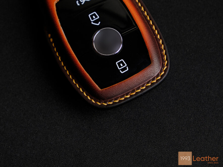 Close-up of a Mercedes A-Class key fob cover featuring luxurious handcrafted stitching on high-quality leather.