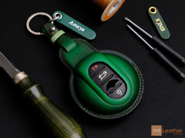 Handmade Patina green leather key fob cover for Mini 5-Door, representing meticulous craftsmanship with tag engraved and keychain.