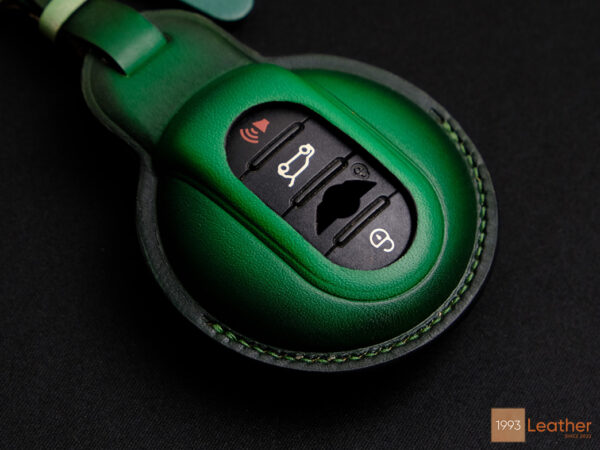 Detailed stitching on green Mini 5-Door key fob cover, representing expert craftsmanship.