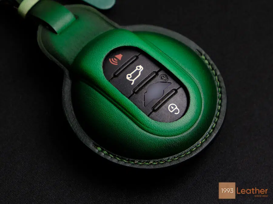 Detailed stitching on green Mini 5-Door key fob cover, representing expert craftsmanship.
