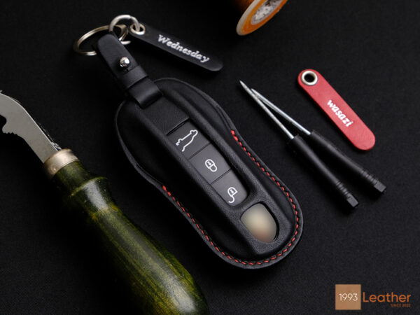 Porsche Macan key fob cover in elegant black leather, offering a luxurious look.