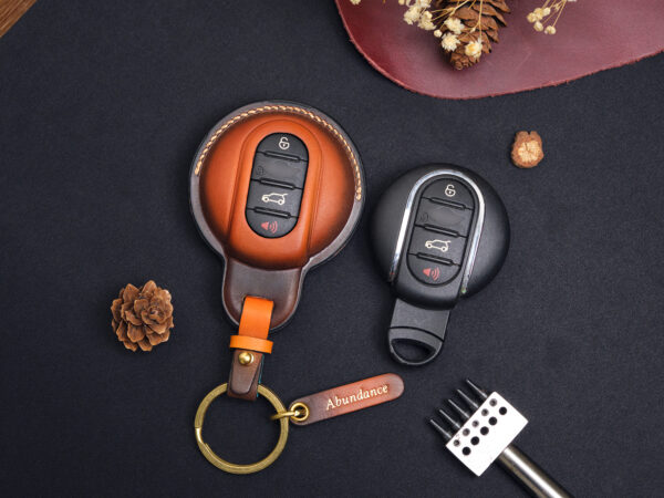 Mini Clubman key fob covers in red, green, and brown with personalized name tags and customizable hardware at Leather1993.