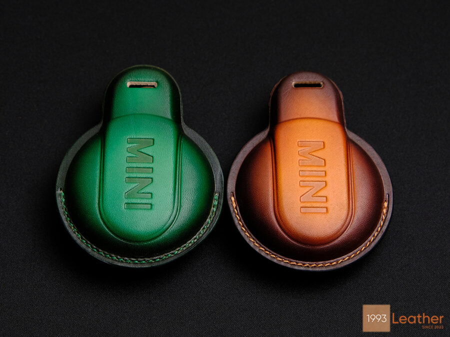 Back view of the high-end Mini Clubman key fob covers in green and brown leather with embossed MINI logo, representing craftsmanship at Leather1993.