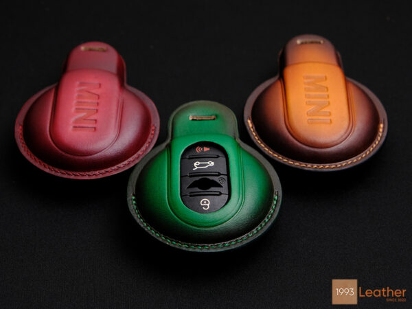 Mini Clubman key fob covers in vibrant green, red, and patina orange showcasing a wide range of color choices.