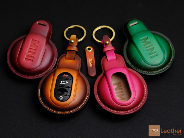 Mini Clubman key fob covers in red, green, and brown with personalized name tags and customizable hardware at Leather1993.