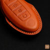 Close-up of Nissan Titan key fob cover featuring exquisite stitching details.