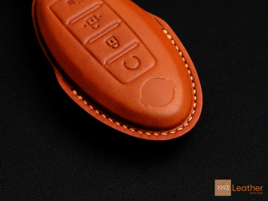 Close-up of Nissan Titan key fob cover featuring exquisite stitching details.