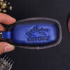 The back side of Ford Edge Key fob cover with keychain and tag