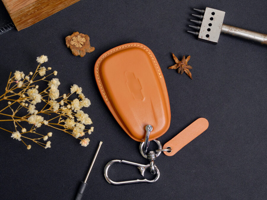 Two Chevrolet Camaro key fob covers with free engraved tag and keychain showing Chevy logo