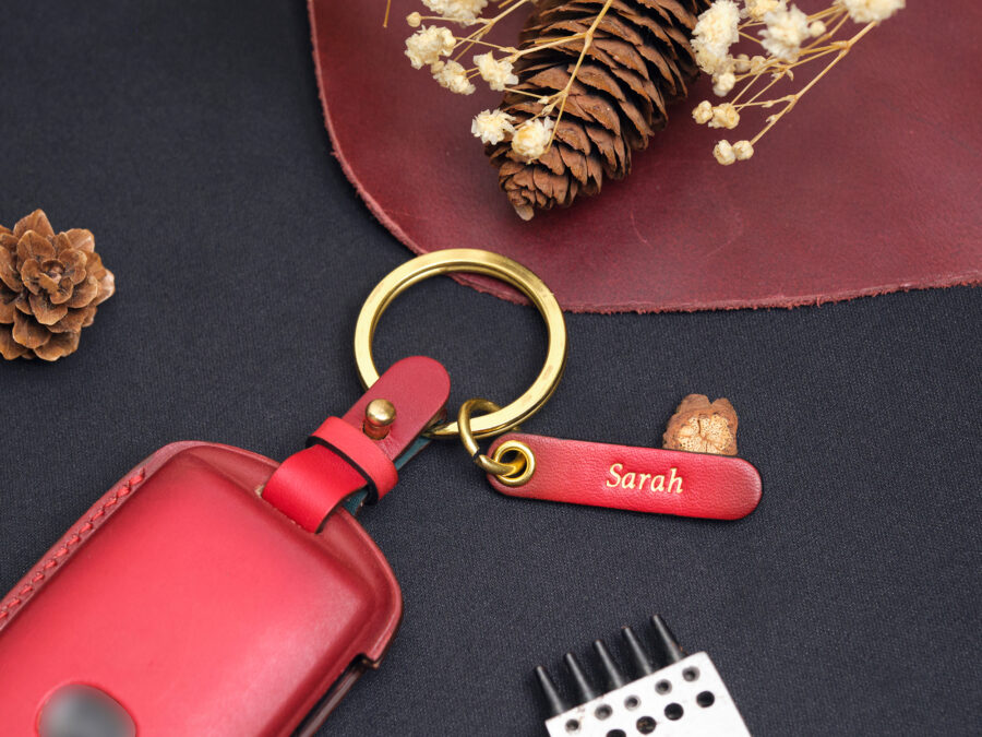 Orange leather Mazda CX-60 key fob case, handcrafted from high-quality leather, highlighted with yellow metal key chain