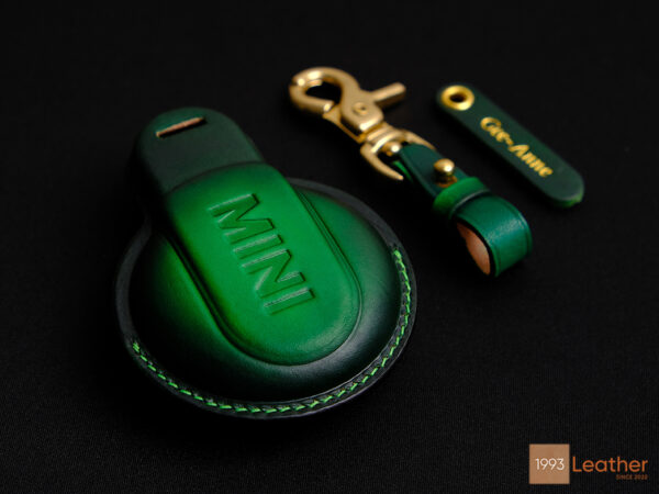 Detailed green stitching on Mini JCW leather key fob cover, representing premium craftsmanship.