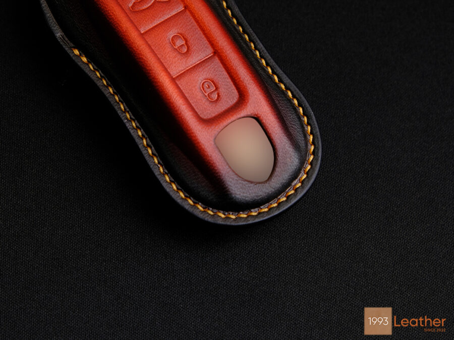 Close-up of the Porsche 911 key fob cover, highlighting the meticulous stitching crafted by expert artisans.