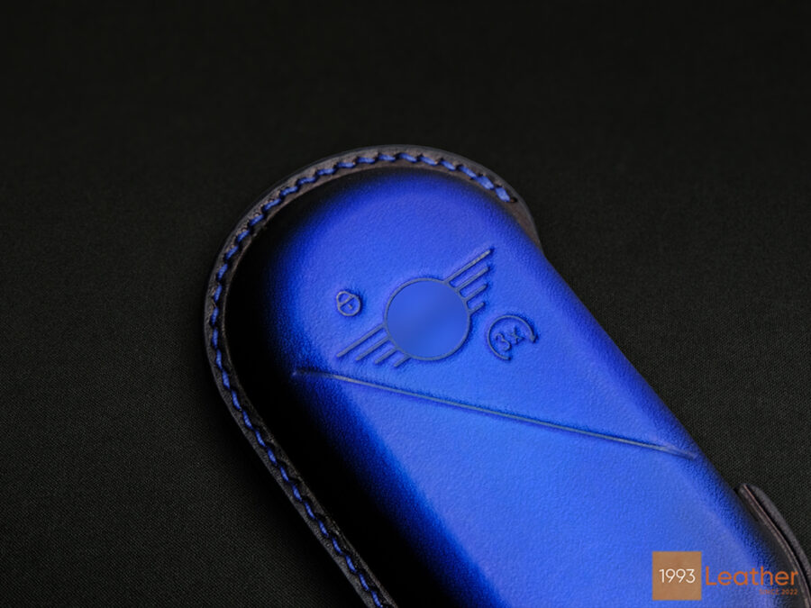 Close-up of the meticulously crafted stitching on a Patina Blue Mini Aceman key fob cover