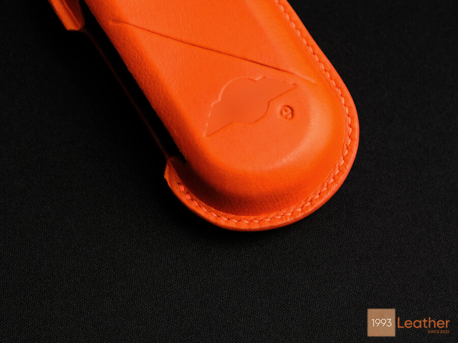 Close-up view of a Mini Cooper SE key fob cover representing meticulous stitching and craftsmanship.