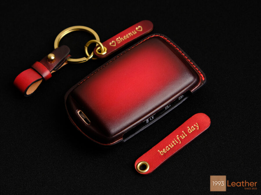 Mazda 2, 3, 6 key fob cover made of premium leather with Patina red finish, personalized name tags, and gold hardware.