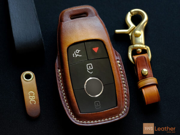 Mercedes E-Class key fob cover made of veg-tanned leather, featuring a free engraved tag and hardware with four customizable options.