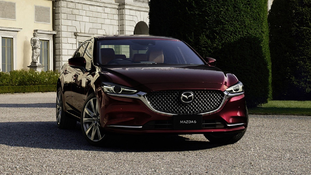 Mazda 6 featuring a sleek sedan design, with sharp lines, a bold front grille, and elegant alloy wheels.