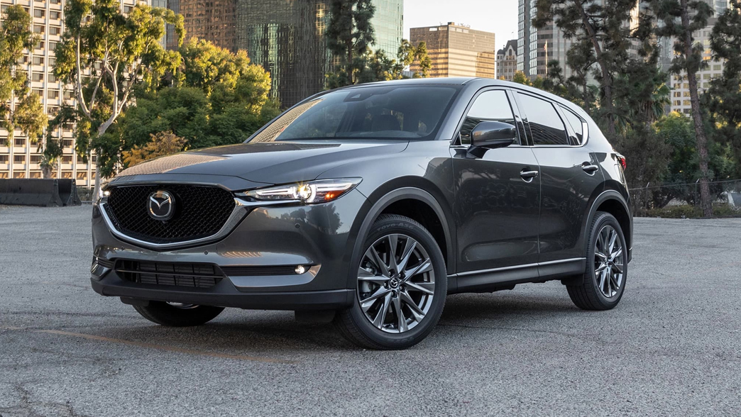 Mazda CX-5 with a stylish SUV design, featuring a bold front grille, smooth curves, and modern alloy wheels.