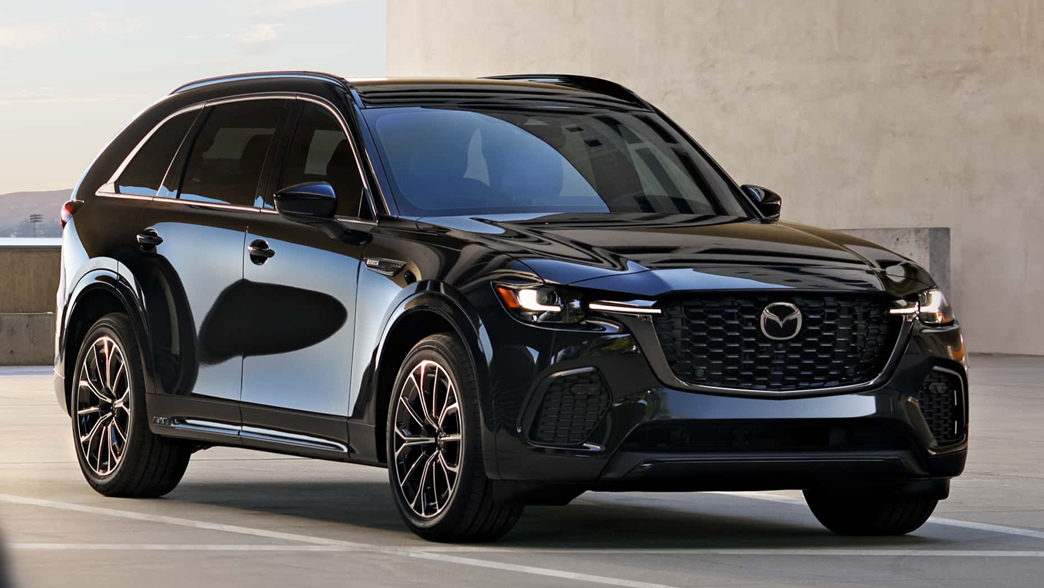 Mazda CX-70 with a robust SUV design, featuring bold lines, a distinctive front grille, and strong alloy wheels.