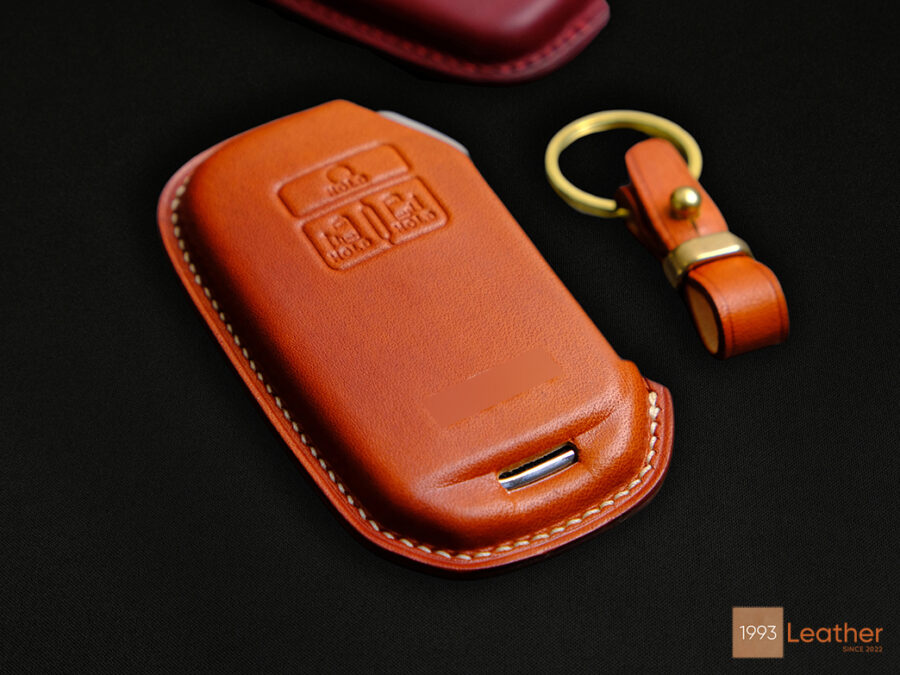 The front of the KIA Carnival key case has a 3-button embossed or exposed-button design.