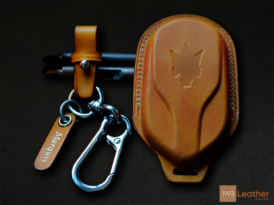 Maserati Quattroporte key case, highlighting sophisticated stitching details on high-quality leather.