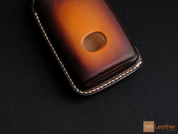 Close-up of the Mazda CX-5, CX-50 key fob cover representing the refined stitching on premium brown leather.