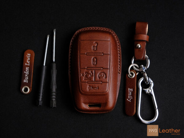 RAM 1500 leather key fob cover made from high-quality veg-tanned leather, featuring personalized tags and durable hardware.