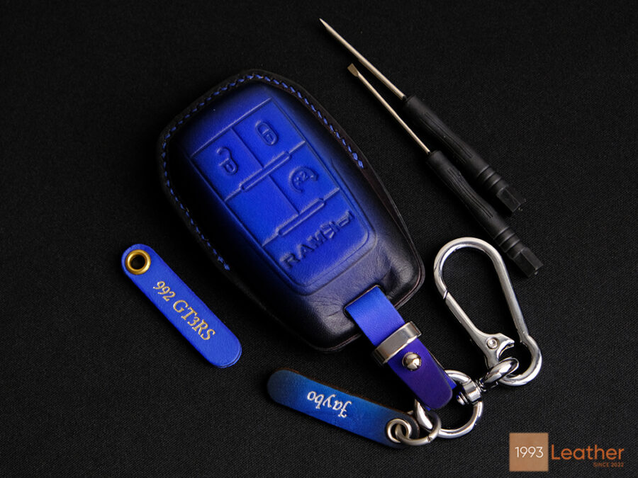 RAM 2500 key fob cover made of imported veg-tanned leather in deep blue, featuring a polished design and durability.