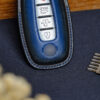 Nissan Maxima key fob cover with intricate stitching representing refined craftsmanship.