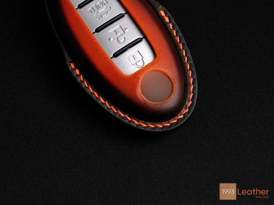 Nissan Maxima key fob cover with intricate stitching showcasing refined craftsmanship.