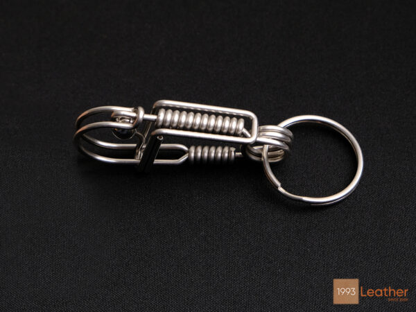 Stainless steel keychain with a spring-loaded locking mechanism for secure key attachment.