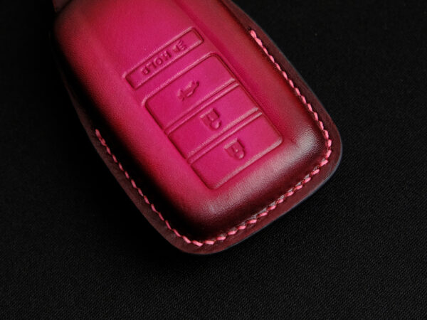 Close-up of Acura TLX leather key fob cover highlighting exquisite hand stitching