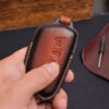 Fully-covered Volkswagen ID leather key fob cover in the front side when holding in hand with comfortable grip