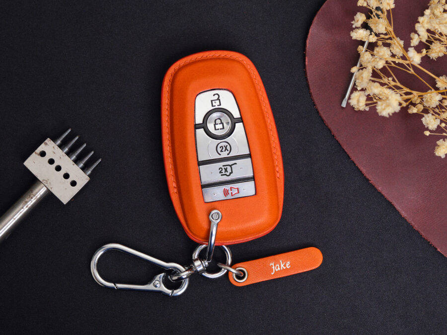Orange leather Ford Expedition key fob cover with metal keyring and engraved leather tag