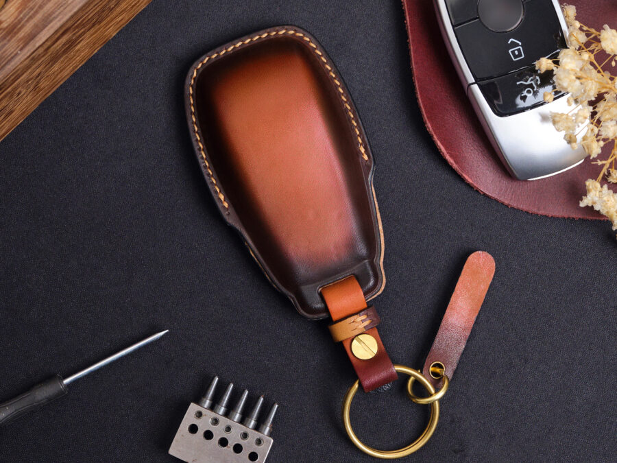 The back of two Mercedes GLC-Class key fob covers with free keychain and tag