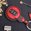 Red leather key fob cover front view showing button layout with contrast stitching