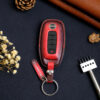 Two color versions and design styles of Nissan Sentra key fob cover in exposed buttons and fully covered with tag and keychain