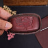 Handcrafted leather RAM 2500 key fob cover with embossed ram logo on back side in deep burgundy leather