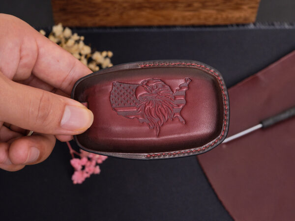 Handcrafted leather RAM 2500 key fob cover with embossed ram logo on back side in deep burgundy leather