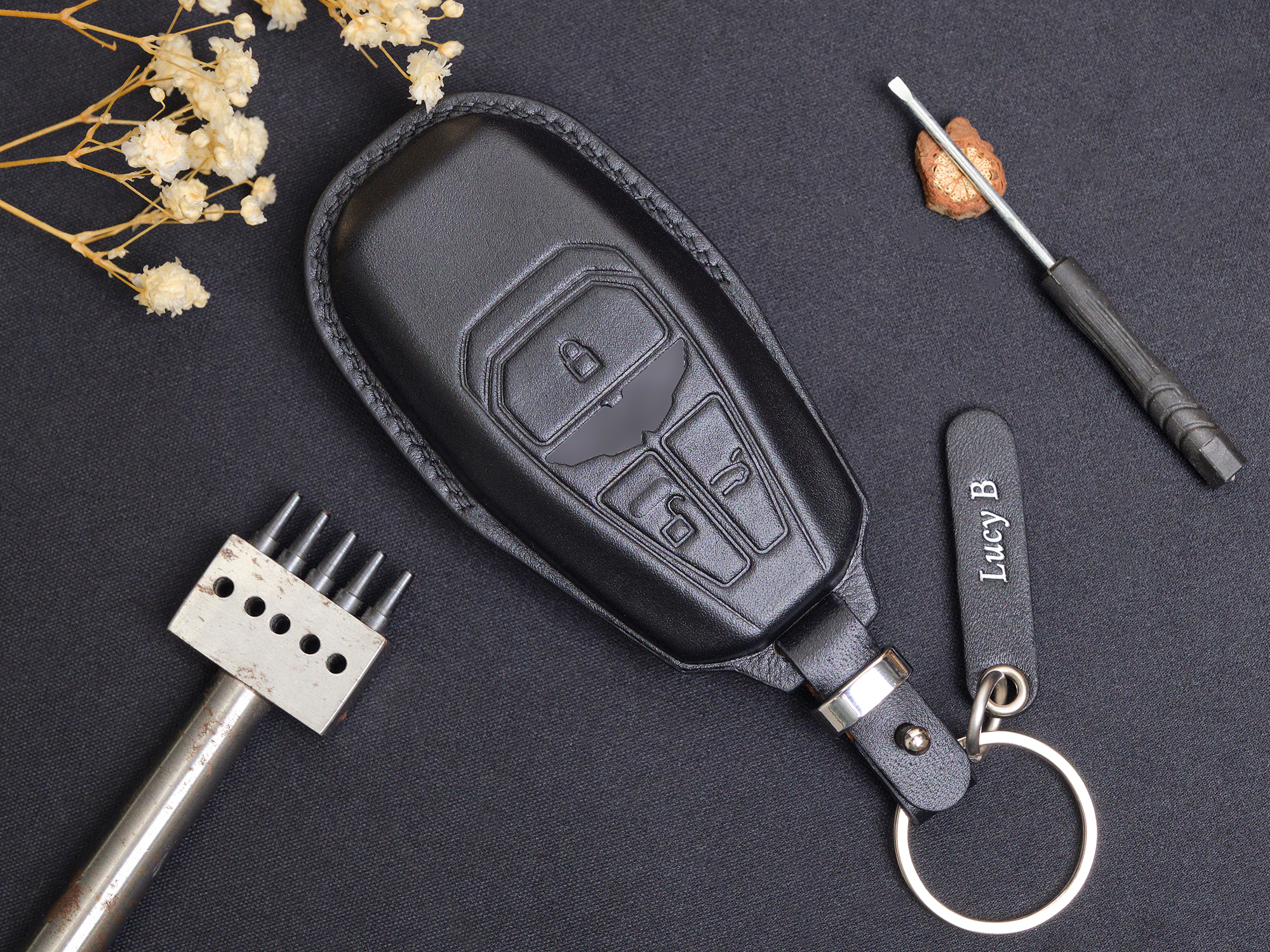 Luxury key fob cover for Aston Martin DB12 made of natural Vegtan leather, offering durability and a sophisticated aged finish over time.