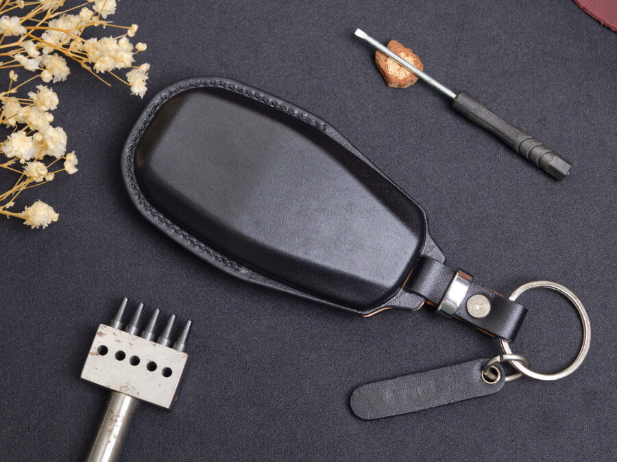 High-quality leather key fob cover for Aston Martin DB12 featuring a snug back design that perfectly contours to the key for secure protection.