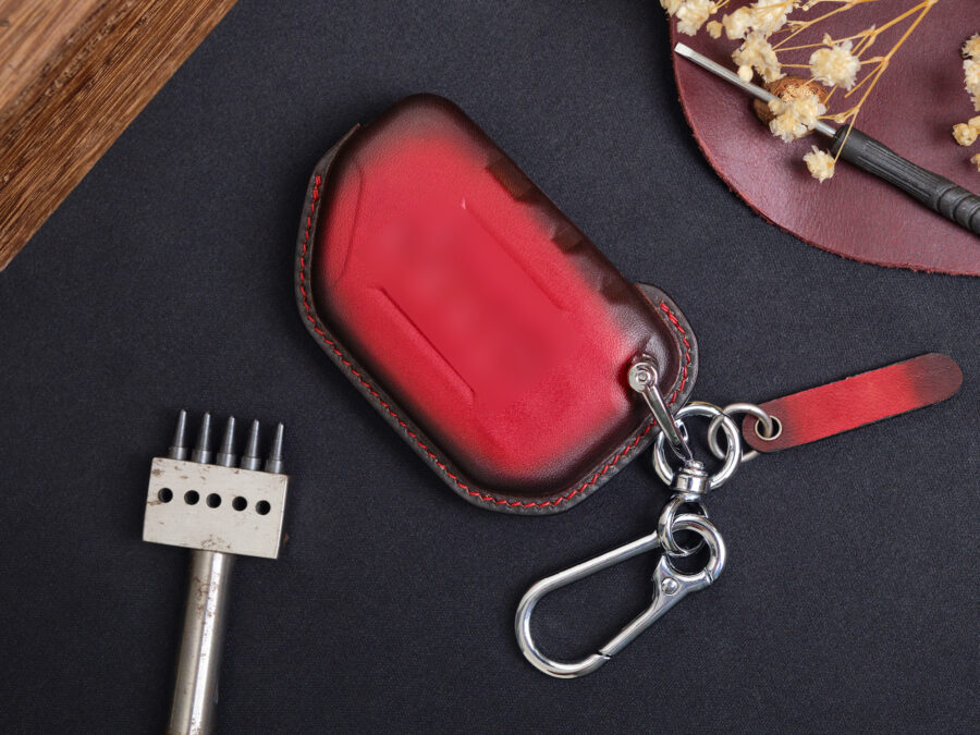 Two color versions of Jeep Wrangler key fob cover in the back side having logo embossed with keychain and free tag engraved